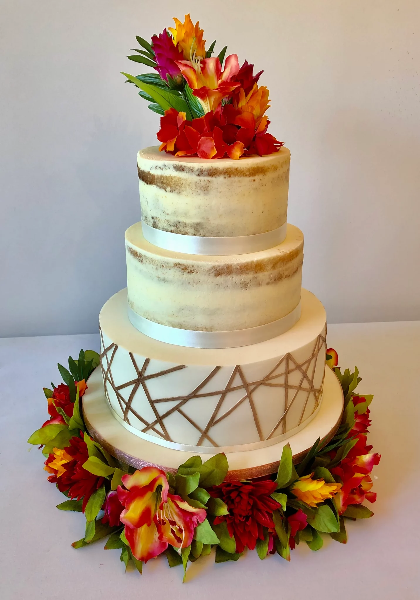 naked theme wedding cakes with flowers on it